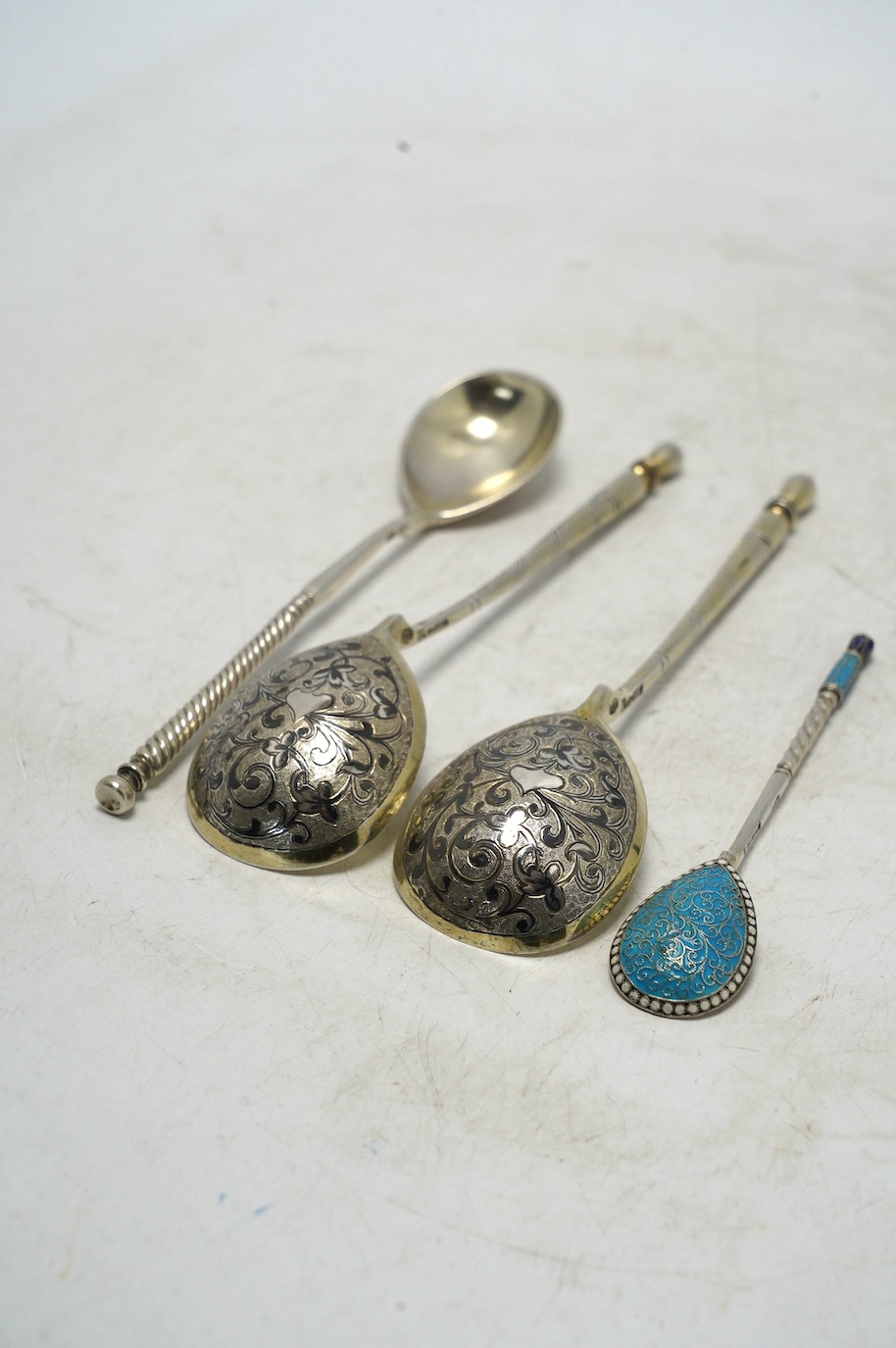 A pair of 19th century Russian 84 zolotnik and niello spoons, 15.5cm and two other Russian spoons including small spoon with cloisonné enamel. Condition - poor to fair